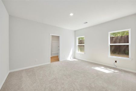 The primary bedroom with large windows, letting in plenty of natural light!