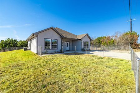 View of front of home with a patio and a front lawn