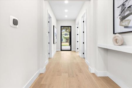 Hall with light hardwood / wood-style floors