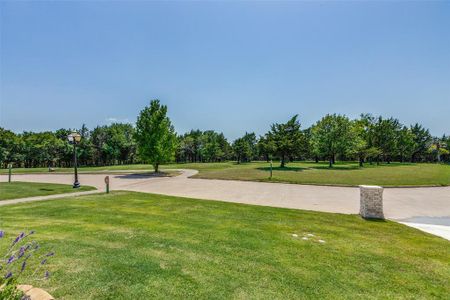 View of home's community with a yard