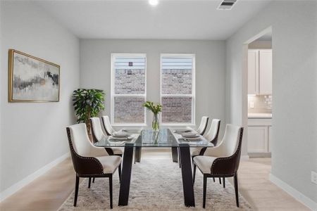 You and your guests will certainly dine in style in this amazing formal dining room! Featuring large windows with blinds, neutral paint, high ceilings, recessed lighting, and tile flooring! Perfect space to entertain family and friends!