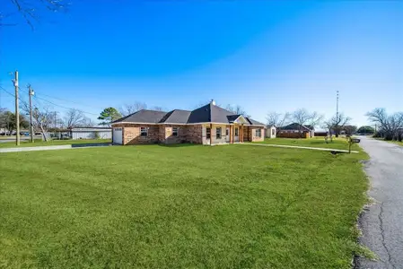 View of side of home featuring a yard