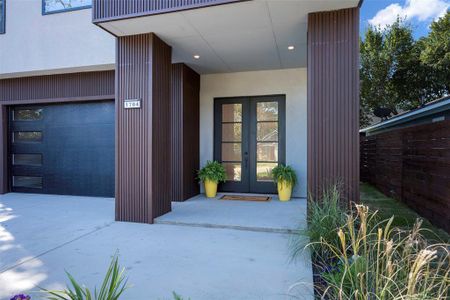 Property entrance with a garage and french doors