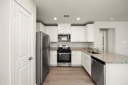 This chef-ready kitchen comes with Whirlpool kitchen appliances and granite countertops.