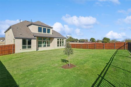 Rear view of house with a yard