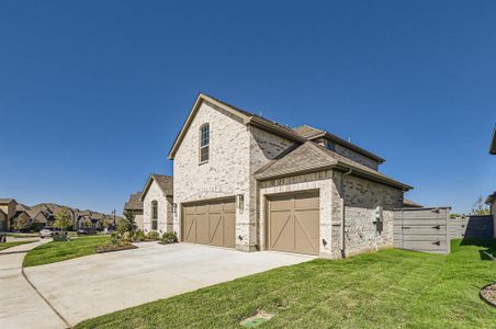 View of home's exterior featuring a garage and a lawn