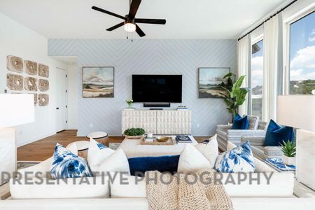 Living area featuring ceiling fan, baseboards, and wood finished floors