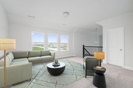 Carpeted living area featuring baseboards and visible vents