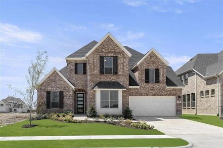 View of front of home featuring a front lawn and a garage