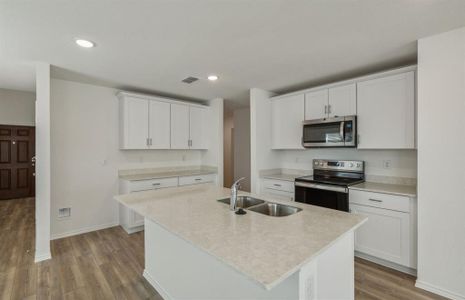 Airy kitchen with oversized island *real home pictured