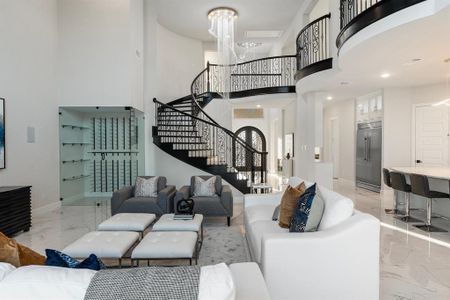 Living room with a high ceiling and a chandelier