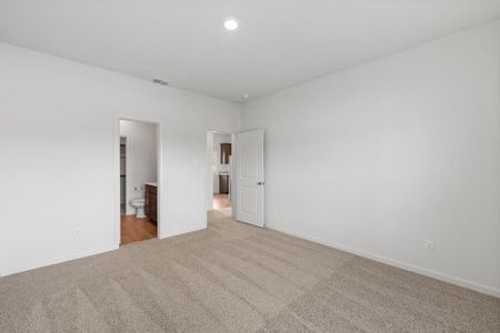 Bedroom featuring light colored carpet