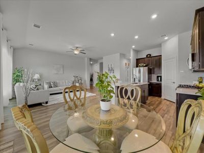 Dining space featuring light hardwood / wood-style flooring, sink, and ceiling fan