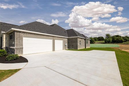 View of property exterior with a garage and a yard