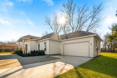 Ranch-style home featuring a garage and a front yard