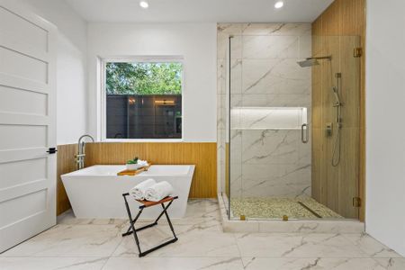 Bathroom featuring tile patterned floors and separate shower and tub