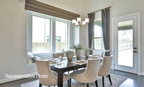 Dining space with dark hardwood / wood-style floors and a chandelier