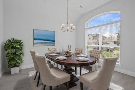 Make memories gathered around the table with your family and friends! This dining room features high ceilings, large windows, wood look tile and a beautiful chandelier.