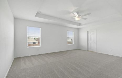 Elegant owner's suite with tray ceiling *real home pictured