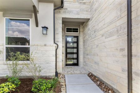 Main entrance walkway with a beautiful modern 9’ door.