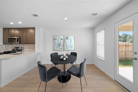 Make memories gathered around the table with your family and friends! This dining room features high ceilings, large windows, and easy access to your kitchen and living room.