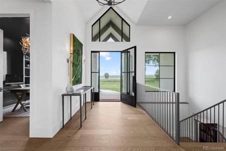 Custom steel and glass door opens to beautiful foyer.