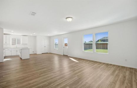 Spacious gathering room with large windows *real home pictured