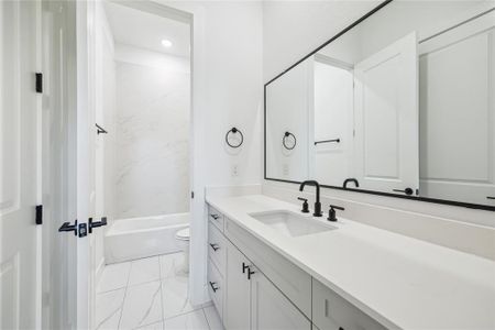 Beautiful quartz, and designer tile in Another one of your bathrooms with shower/tub.