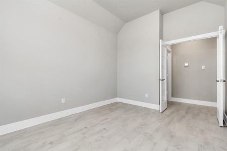 At the forefront of the home, a refined home office beckons productivity and focus. Luxurious details like tile flooring, custom paint, expansive windows with privacy blinds, and French doors create an inspiring workspace. Sample photo of completed home with similar floor plan. As-built interior colors and selections may vary.