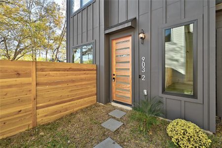 Property entrance with fence and board and batten siding