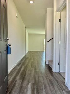 Corridor with dark hardwood / wood-style flooring