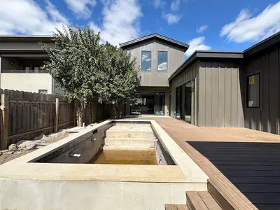 View of swimming pool with a deck and fence