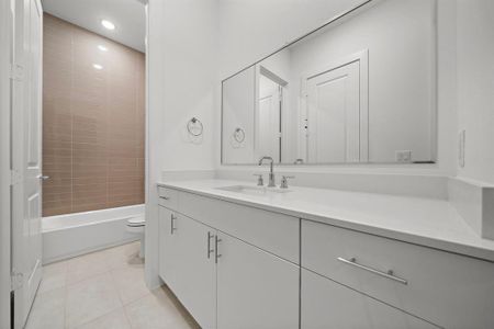 Beautiful quartz, and designer tile in Another one of your bathrooms with shower/tub.