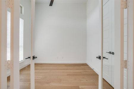 Unfurnished bedroom featuring ceiling fan and light hardwood / wood-style floors