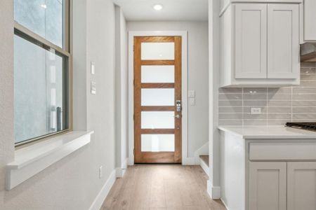 Doorway to outside with light hardwood / wood-style flooring