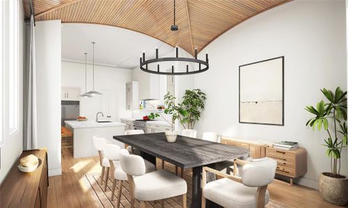 This dining space features a stunning wood-paneled ceiling, cozy textures, and a seamless flow into the kitchen. The ideal spot for gathering and creating memories.