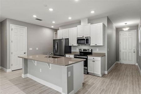 Kitchen with 42" cabinets, quartz countertops and stainless steel appliances