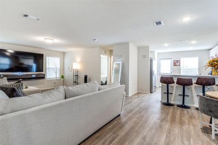 Living room with light hardwood / wood-style floors