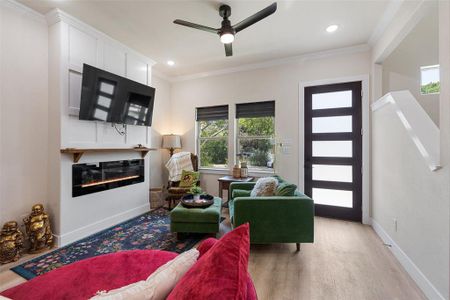 Living room with ceiling fan and luxury vinyl flooring