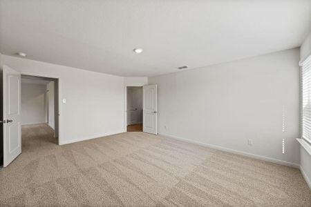 Bedroom featuring light carpet