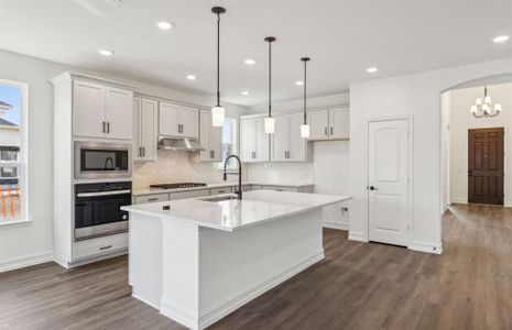 Spacious kitchen with oversized island *real home pictured