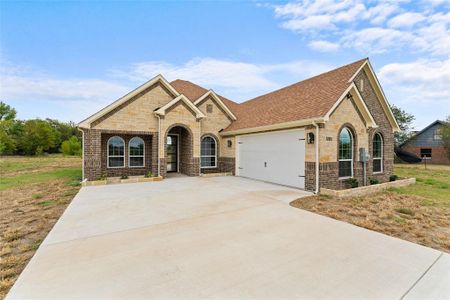 View of front of home featuring a garage and a front yard