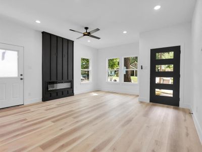 Unfurnished living room with light hardwood / wood-style flooring and ceiling fan