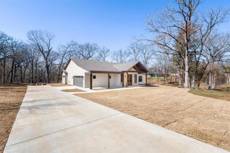 View of front of home featuring a porch and a garage