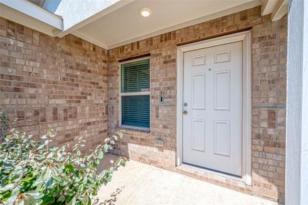 The inviting covered entryway and brickwork create a warm welcome as you step into this lovely home!