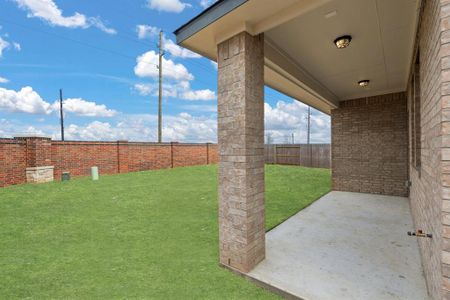 The covered patio is generously sized, providing ample space for various outdoor activities.