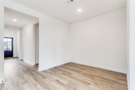 Empty room with light hardwood / wood-style flooring