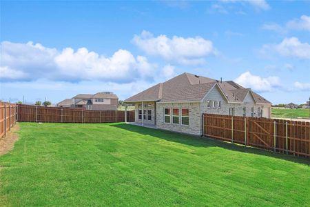 Back of house with a yard and a patio area