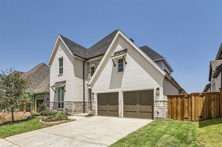 View of front of house with a front yard and a garage