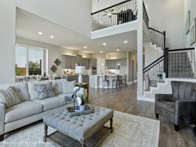 Living room featuring sink, a high ceiling, and dark hardwood / wood-style floors